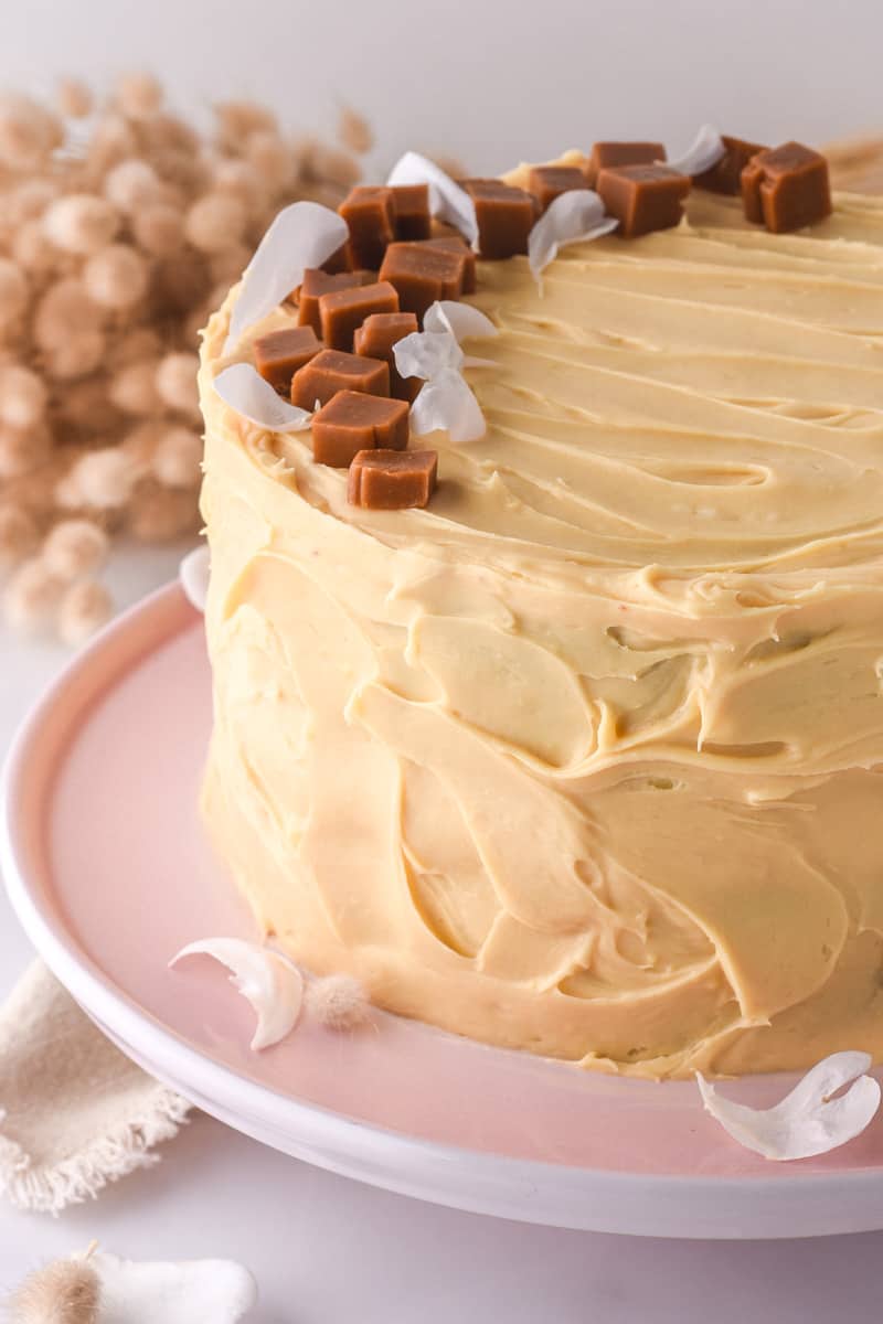 Salted Caramel Buttercream shown swirled onto a vanilla layer cake.