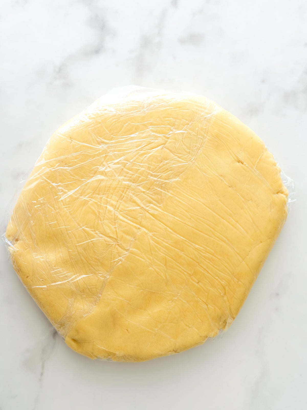 Image shows step 4 of how to make the pastry for apple crumble tarts.
