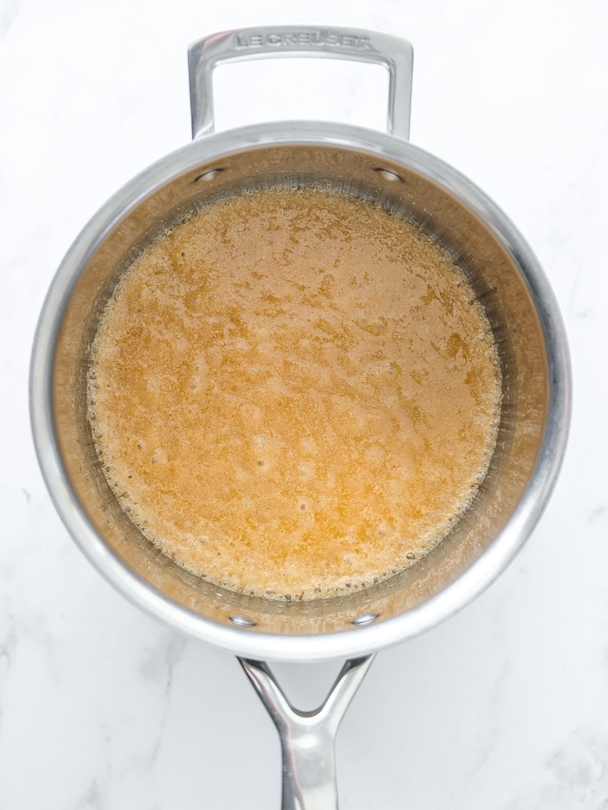 Image shows step 1 of how to make the spiced apple filling for apple crumble tarts.