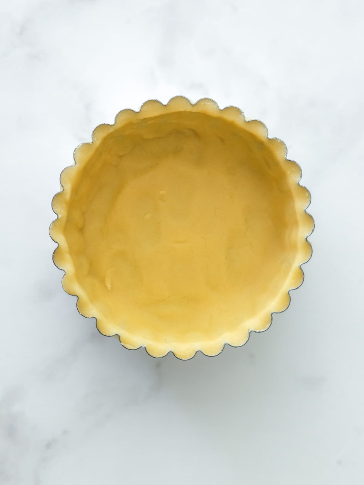 Image shows step 5 of how to make the pastry for apple crumble tarts.