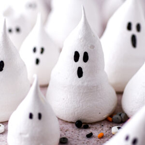 Halloween ghost meringues shown on a kitchen counter.
