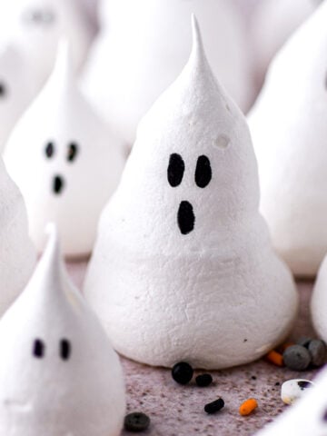 Halloween ghost meringues shown on a kitchen counter.