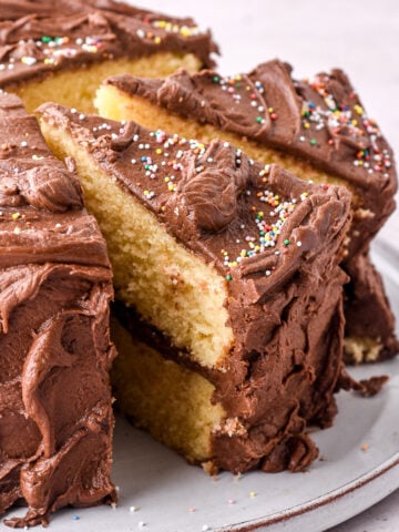 Cake shown on a cake plate with slices cut and slightly removed so that you can see the layers.