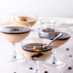 Espresso Panna Cottas shown in martini glasses on a kitchen counter.