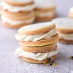 Passionfruit cookies shown stacked on top of one another on a kitchen counter.