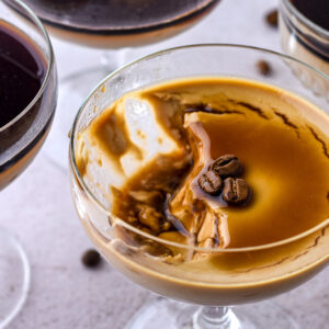 Espresso Panna Cottas shown from above, the one panna cotta has a spoonful of the dessert missing.