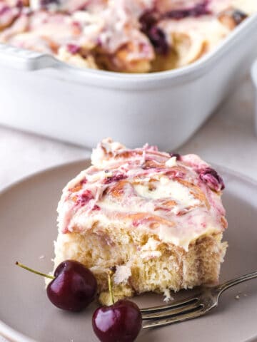 Cherry Cinnamon Roll shown on a grey plate.