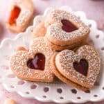 Jam filled cookies shown on a heart plate.