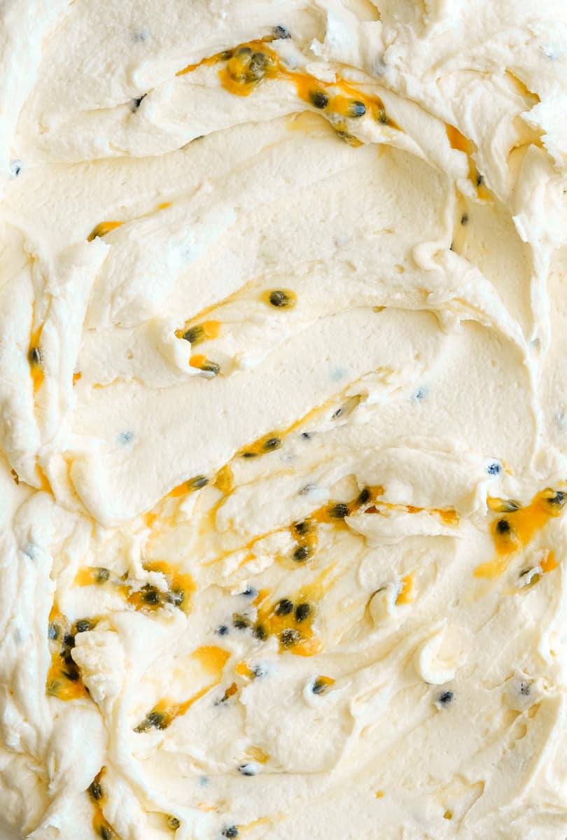 Image showing the frosting up close, passionfruit pulp has been swirled through the frosting. 
