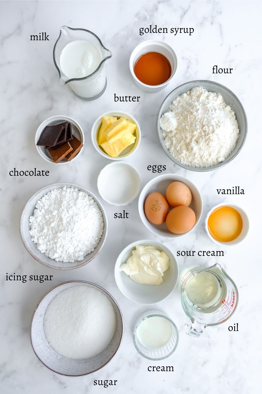 Image shows ingredients needed to make these vanilla and chocolate cupcakes.