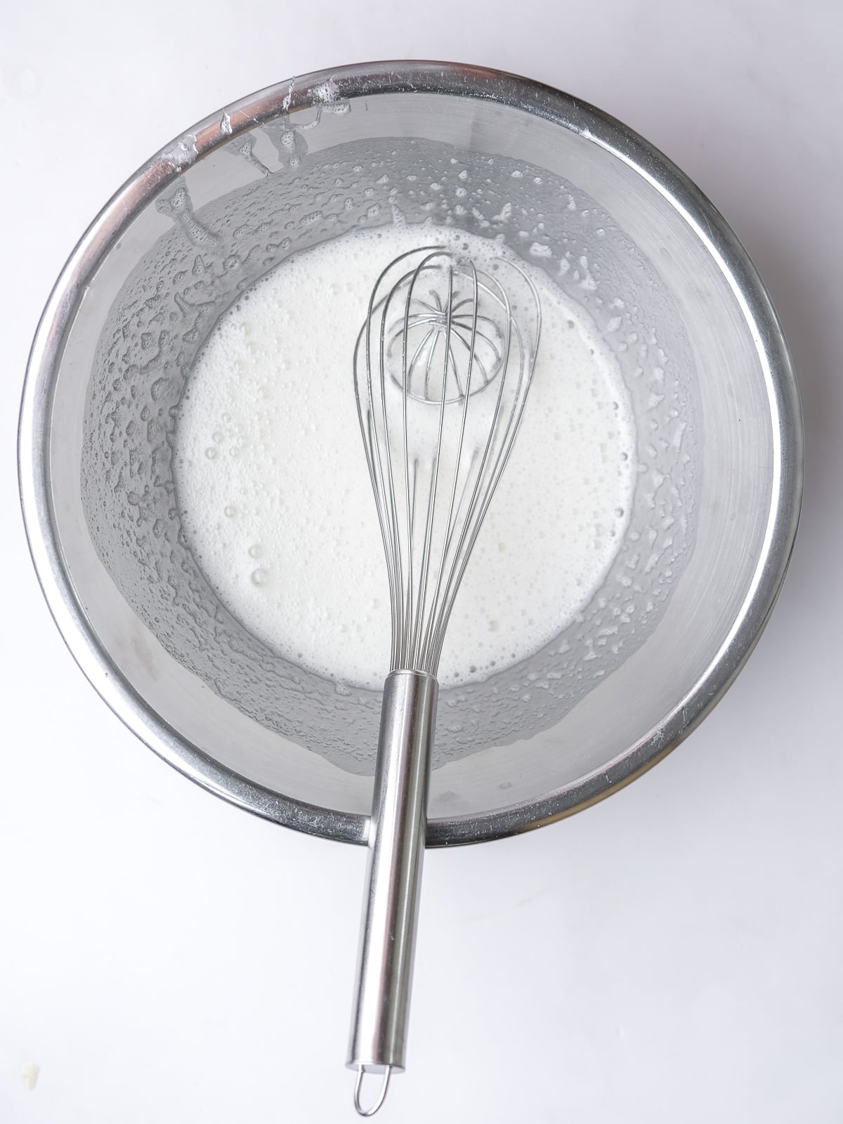 Image shows step 2 of how to make the meringue topping for a lemon meringue pie.