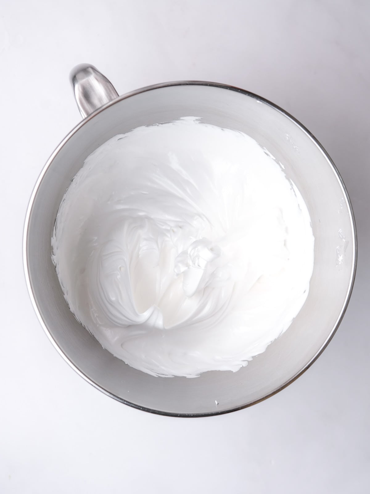 Image shows step 3 of how to make the meringue topping for a lemon meringue pie.
