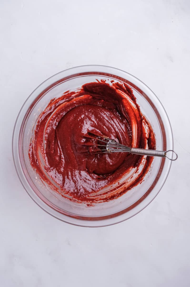 Image shows step 5 of how to make a red velvet mug cake.