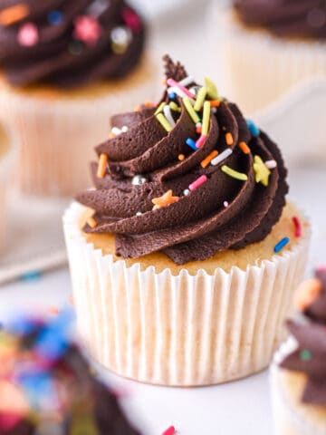 Vanilla Cupcakes with Chocolate Frosting shown on a white kitchen counter