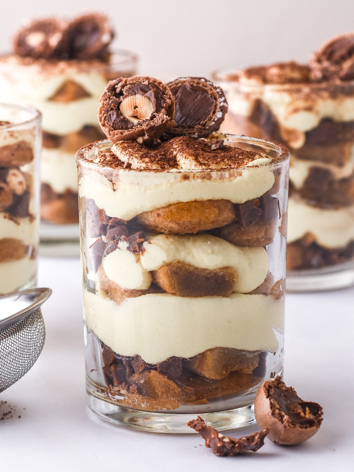 Image showing an up close of the mini tiramisu cup, you can see the distinct layers of the dessert.