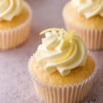 Lemon Drizzle Cupcakes shown on a kitchen counter.