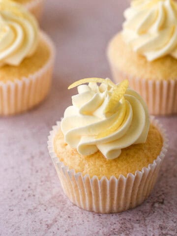 Lemon Drizzle Cupcakes shown on a kitchen counter.