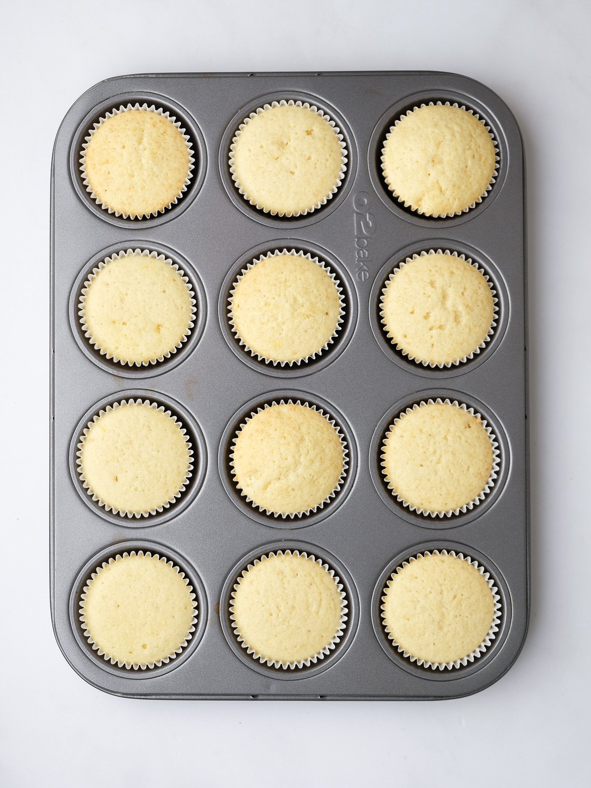 Image shows step 6 of how to make lemon drizzle cupcakes.