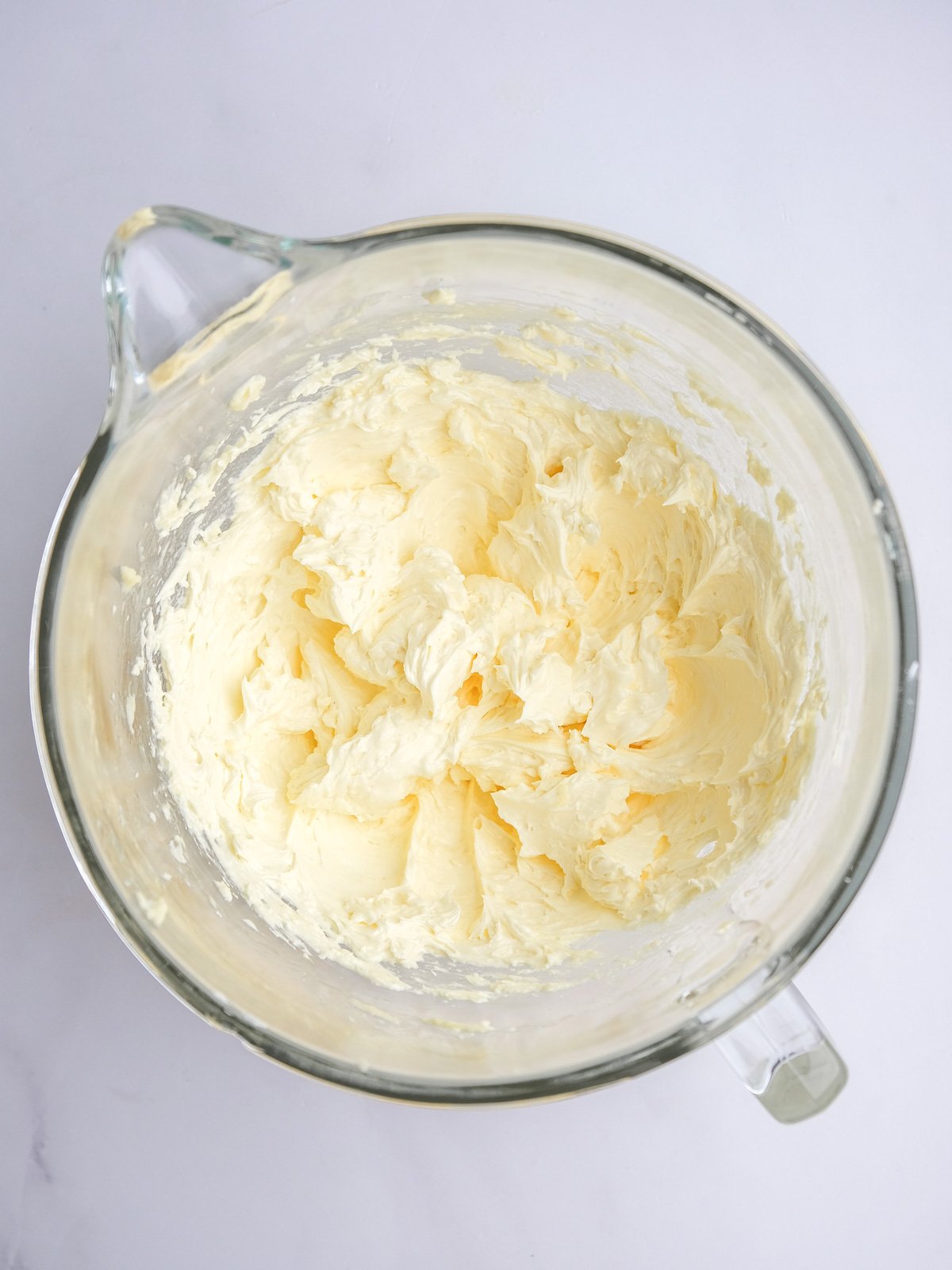 Image shows step 3 of how to make lemon drizzle cupcakes.