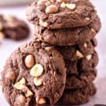 Hazelnut Chocolate Cookies shown stacked on a kitchen counter.