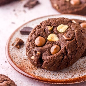 Hazelnut Chocolate Cookie shown on a speckled small plate. You can see the chocolate chips are still melted.
