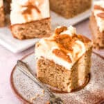 A slice of banana and caramel cake shown on a speckled cake plate.