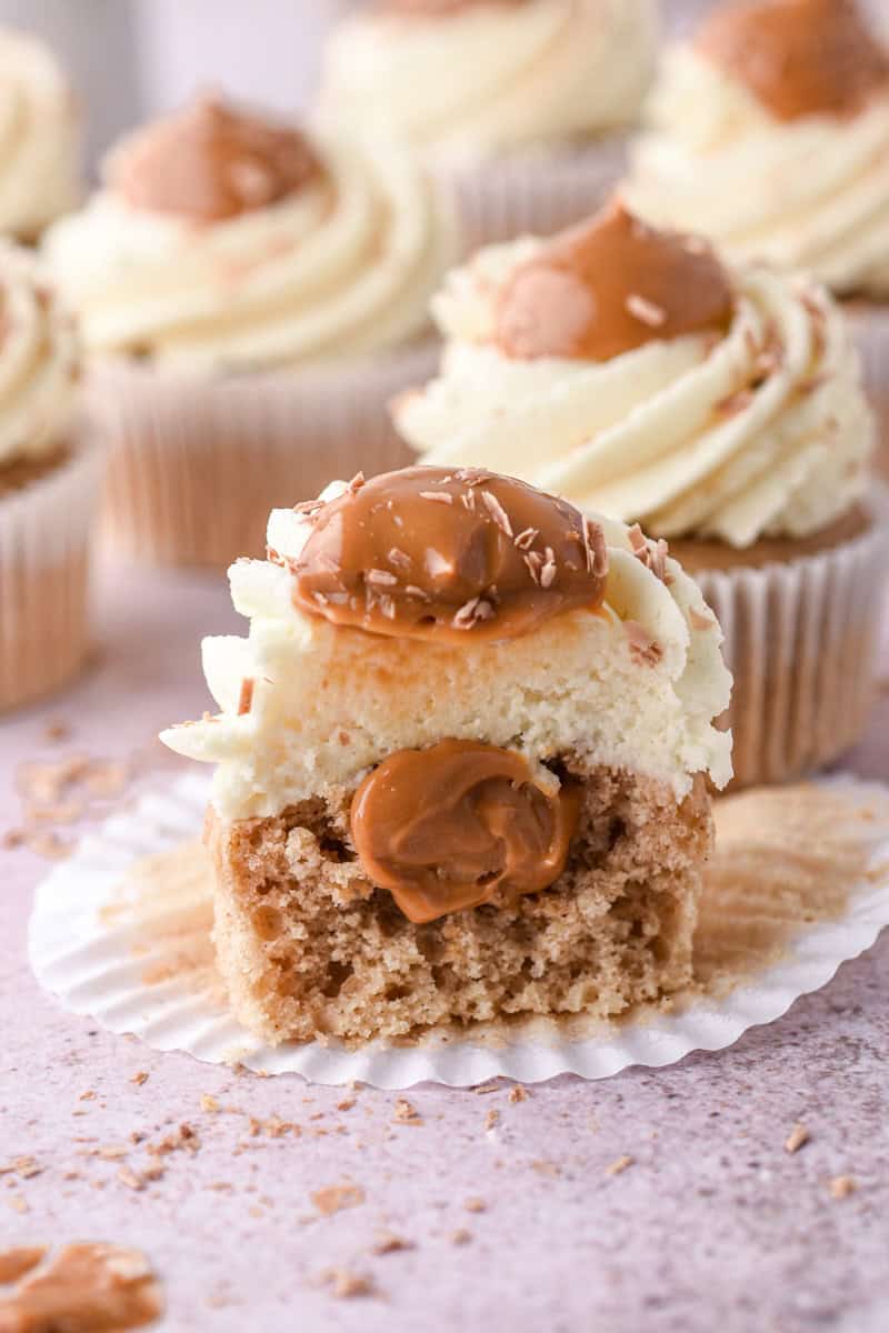Banoffee Cupcake shown up close and cut in half so that you can see the caramel filling.