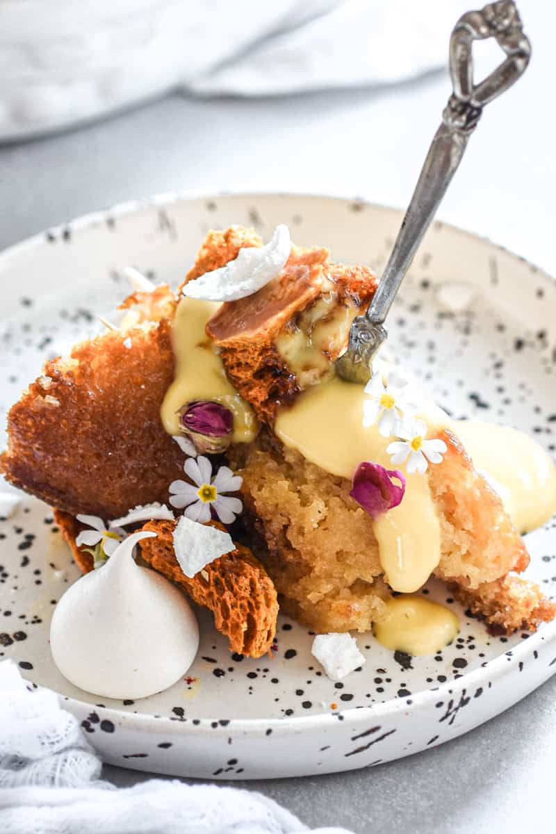 Malva Pudding slice on a plate with custard.