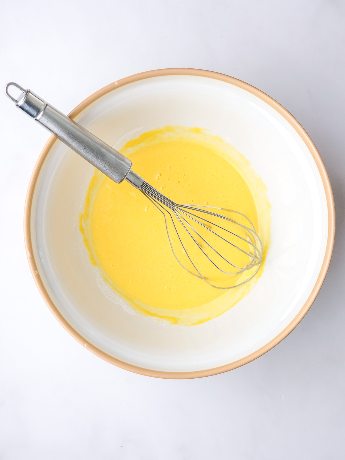 Image shows step 1 of how to make vanilla bean custard.