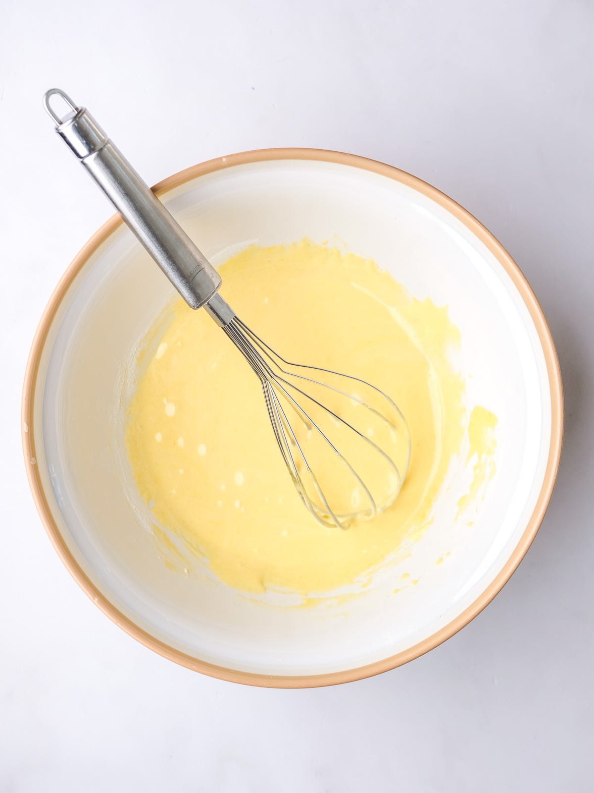 Image shows step 2 of how to make vanilla bean custard.