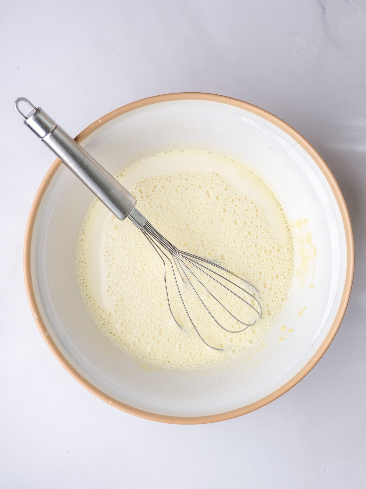 Image shows step 4 of how to make vanilla bean custard.