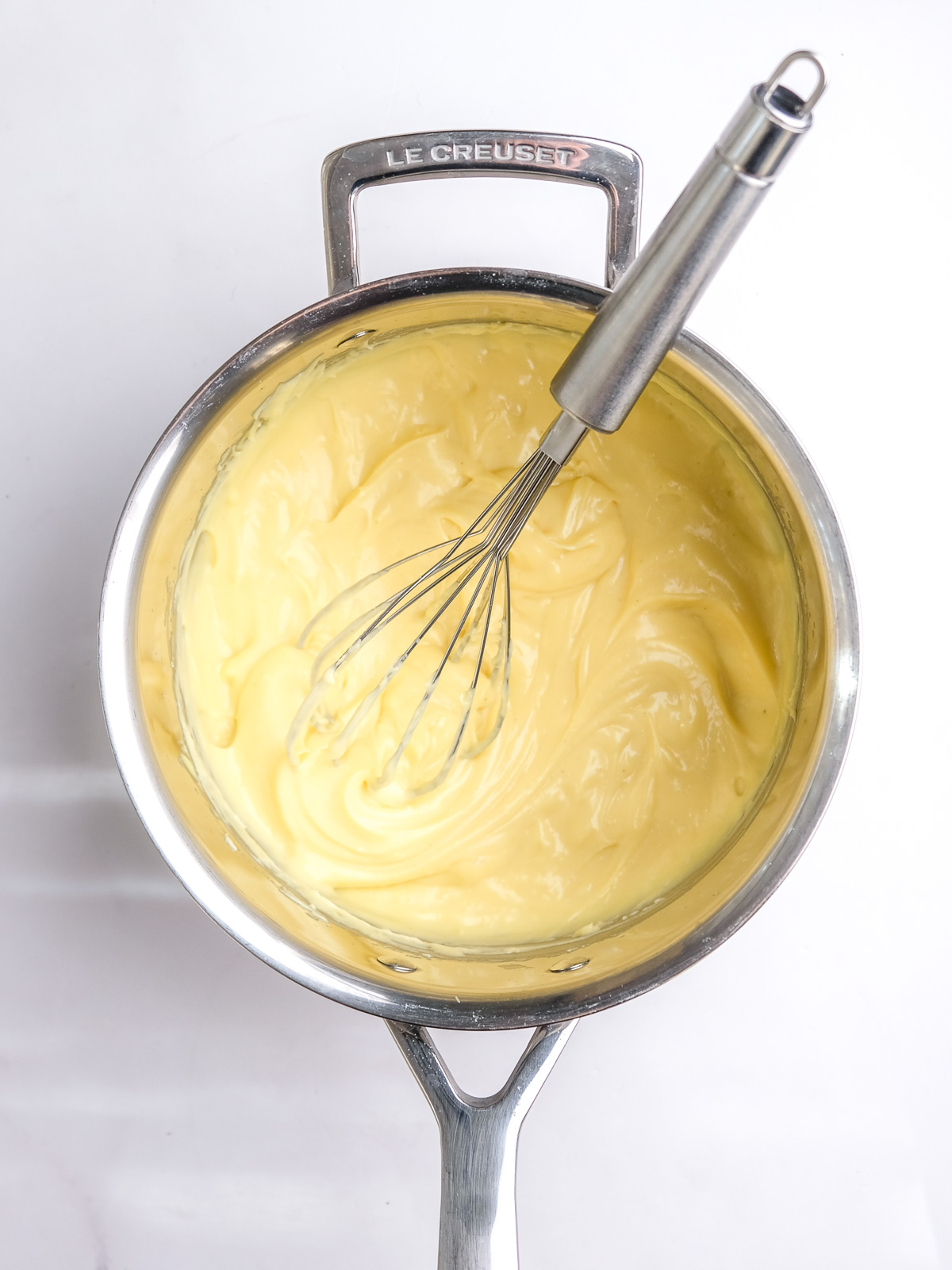 Image shows step 5 of how to make vanilla bean custard.