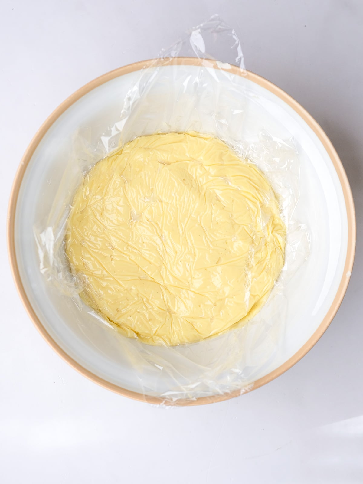 Image shows step 6 of how to make vanilla bean custard.