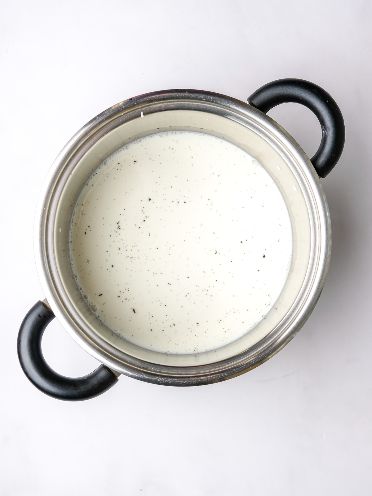 Image shows step 3 of how to make vanilla bean custard.
