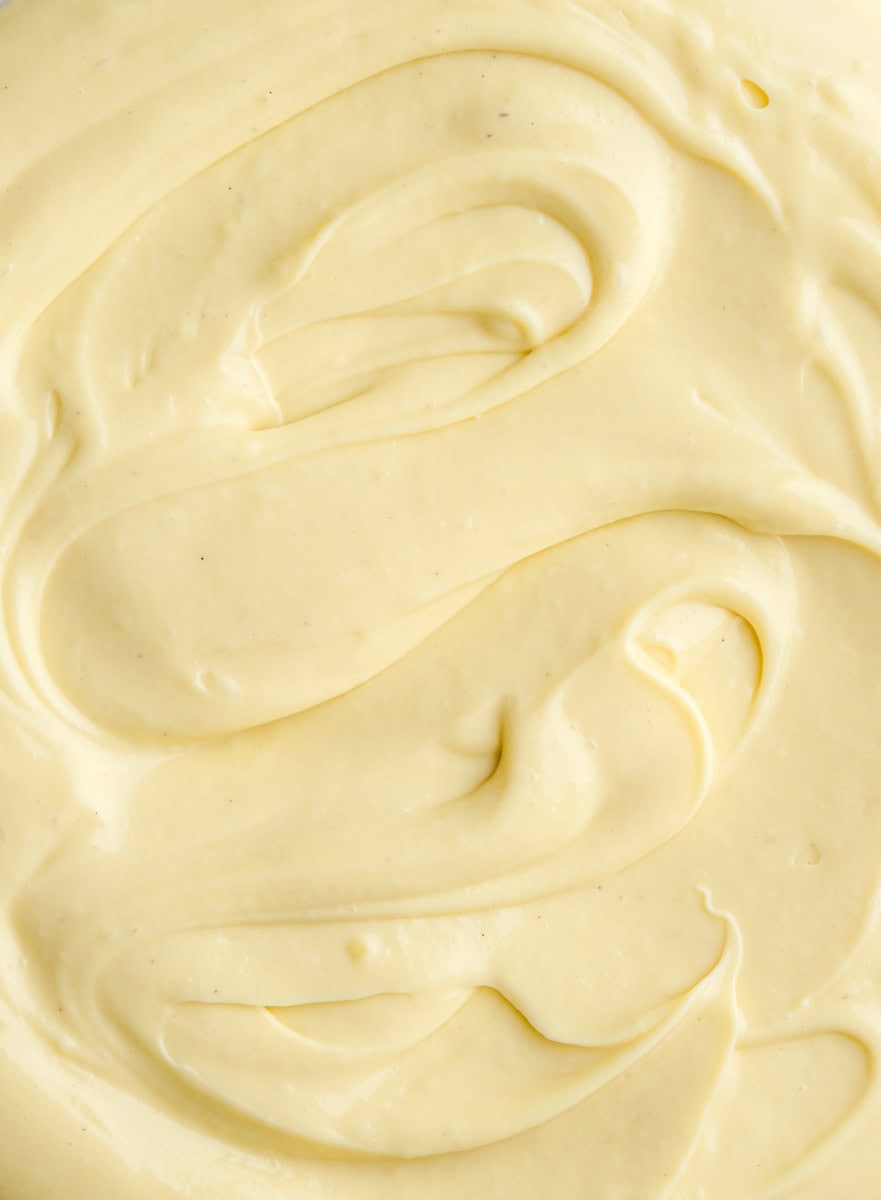 Vanilla Bean Custard shown up close, you can see the swirls of custard and the flecks of the seeds from the vanilla pod. 