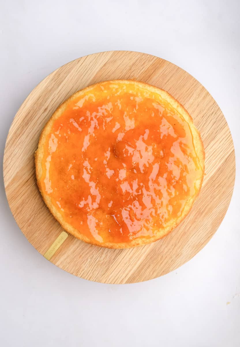 Image shows step 6 of how to make. a hot milk sponge cake.