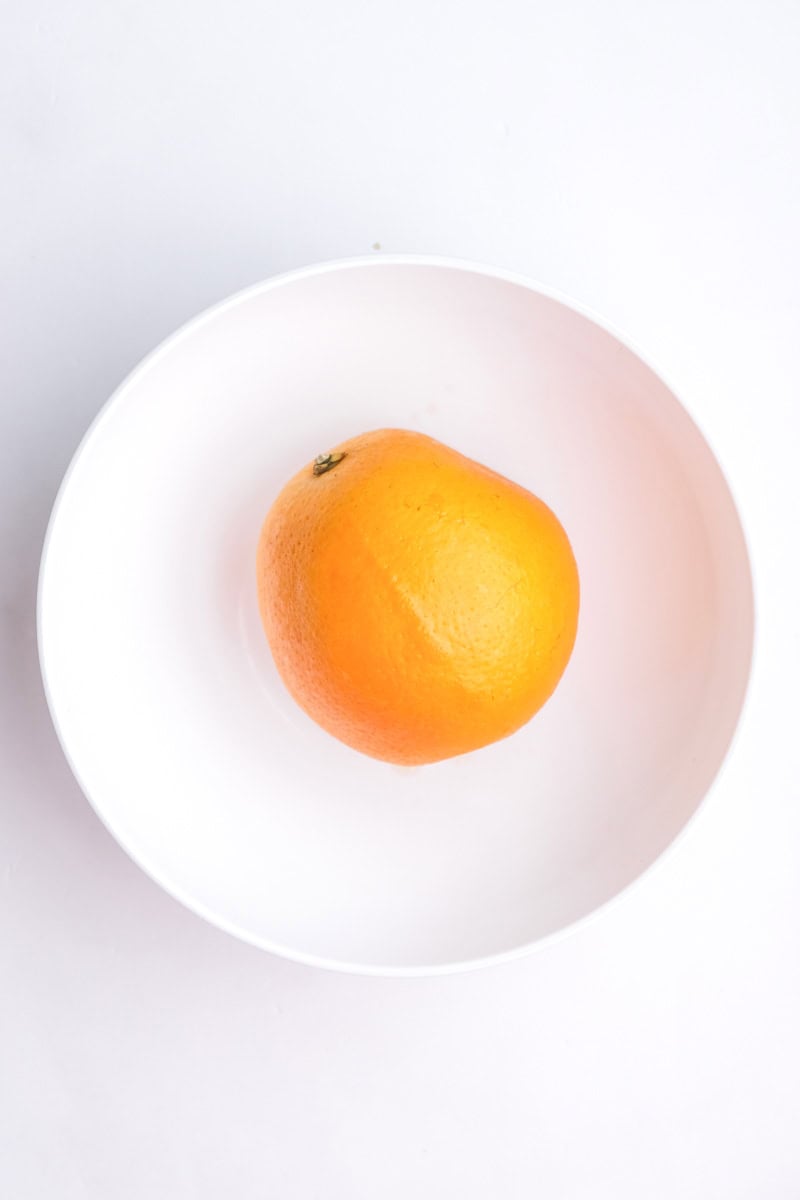 Image shows step 1 of how to prepare the oranges.