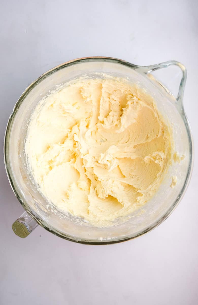 Image shows step 2 of how to make the orange frosting.