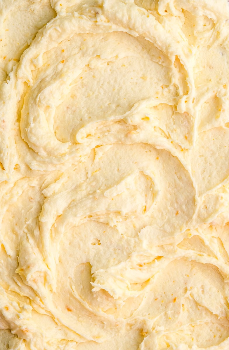 Image shows step 3 of how to make the orange frosting.