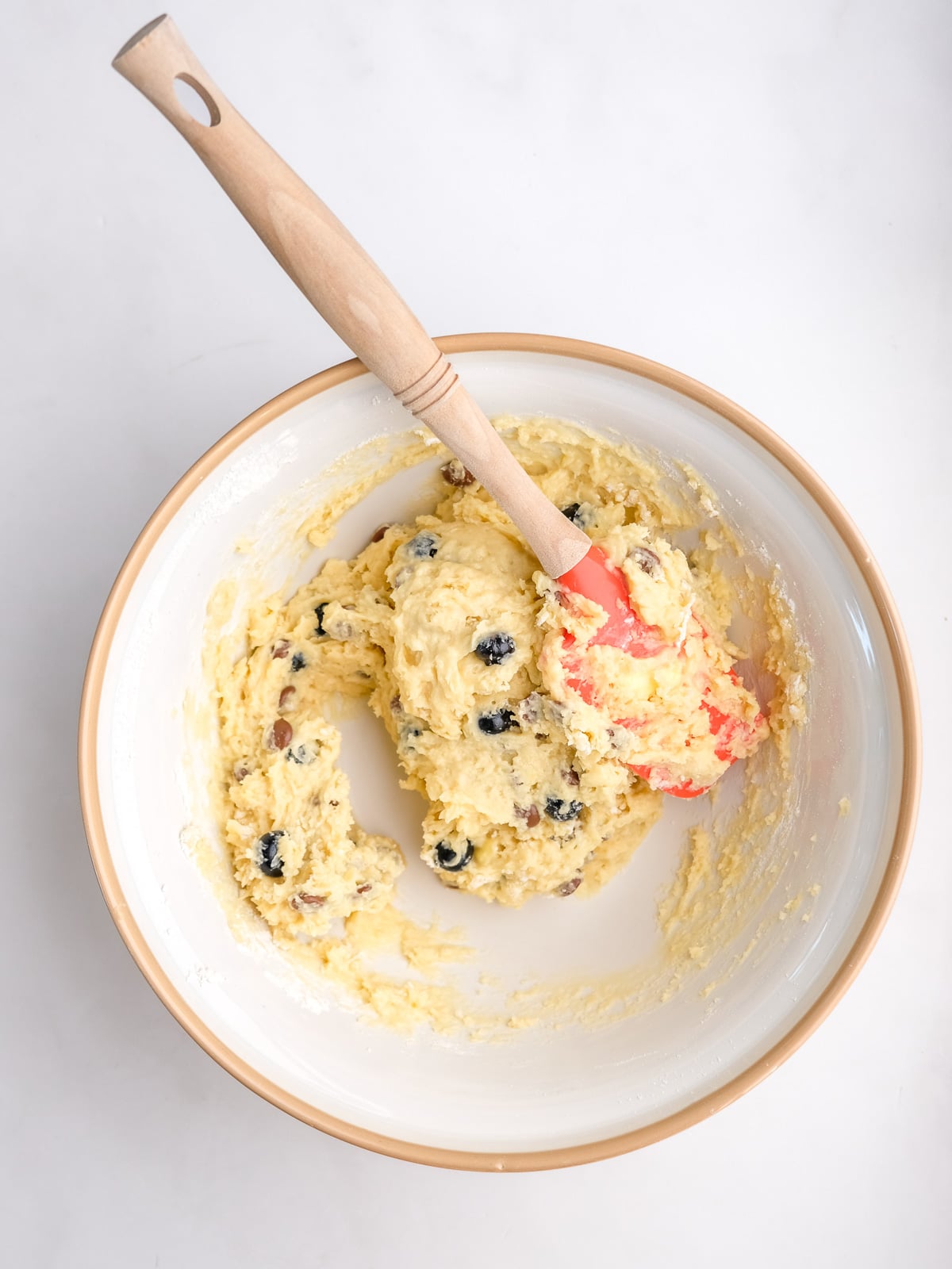 Image shows step 4 of how to make blueberry chocolate chip muffins.