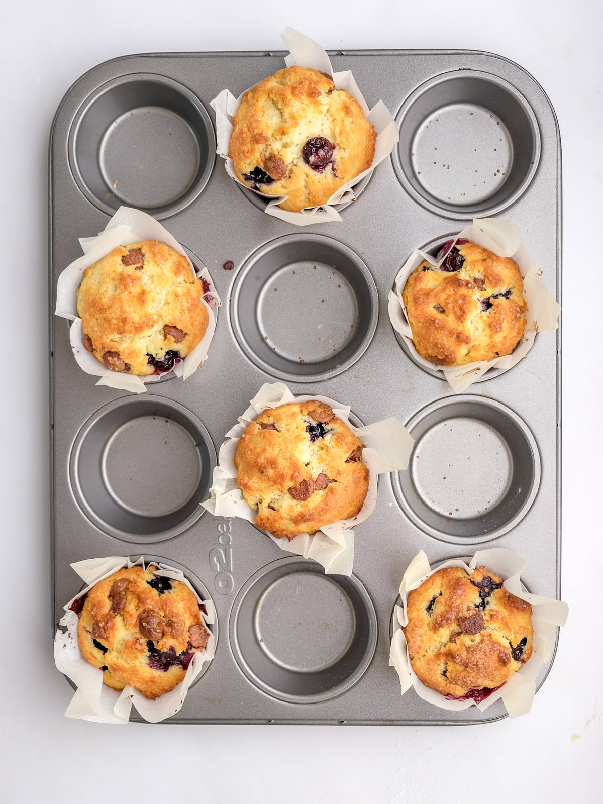 Image shows step 6 of how to make blueberry chocolate chip muffins.