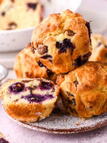 Blueberry and chocolate chip muffins shown piled high on a small side plate.