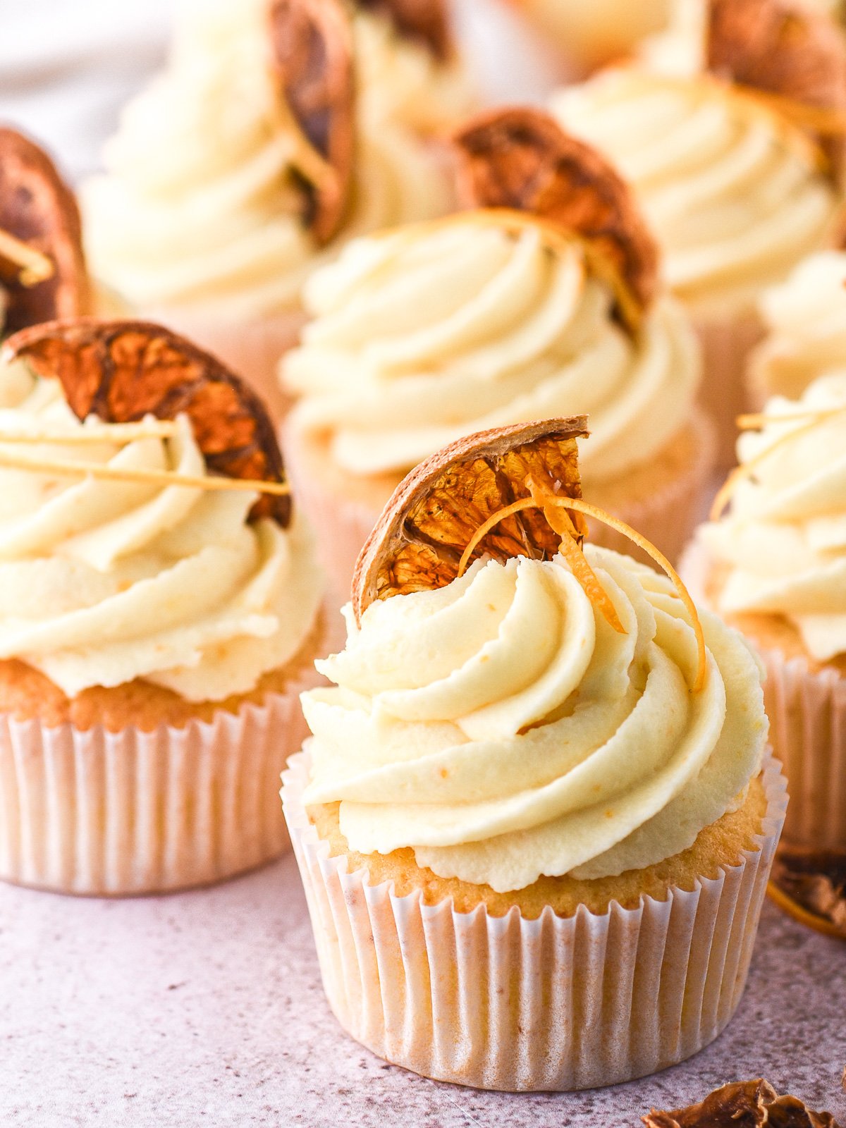 Image shows decorated cupcakes on a kitchen counter.