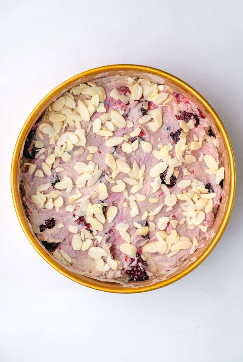 Image shows step 5 of how to make a mixed berry cake.