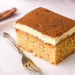 Image shows a slice of the pudding on a plate next to a fork.