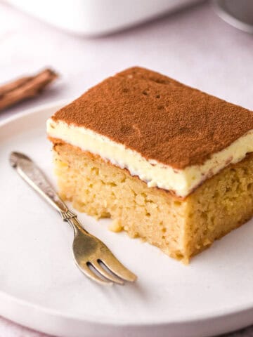 Image shows a slice of the pudding on a plate next to a fork.