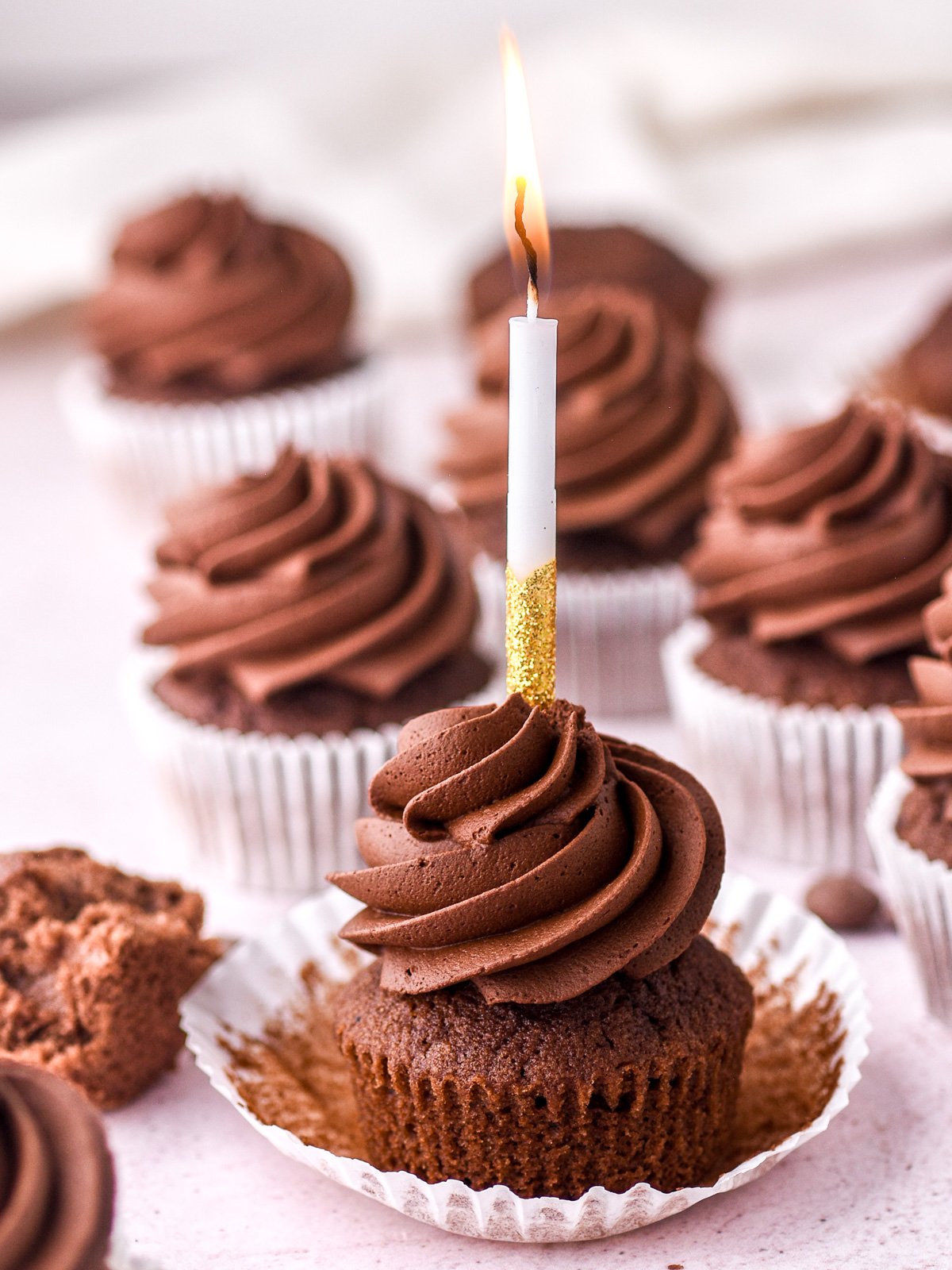 Image showing a decorated cupcake with a birthday candle through the middle of it.