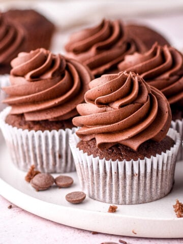 Chocolate Fudge Cupcakes shown decorated on a white plate.