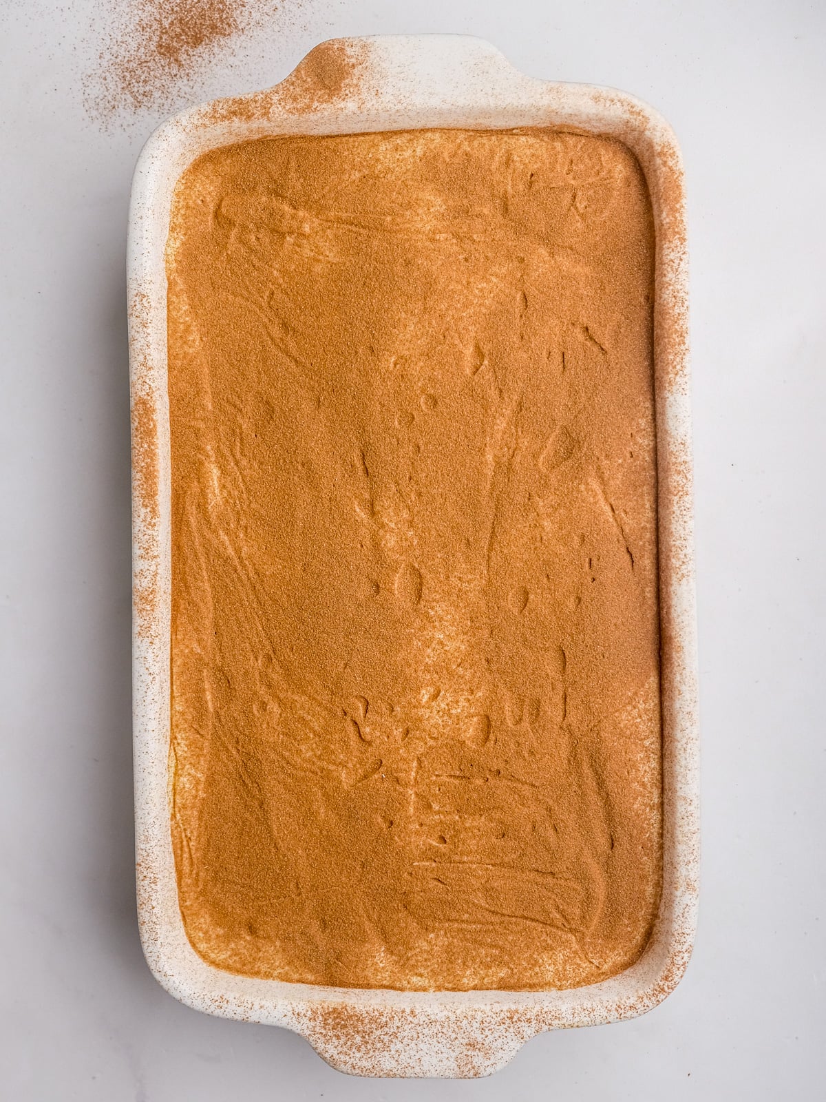 Image shows step 6 of how to make the milk tart layer of this desert.