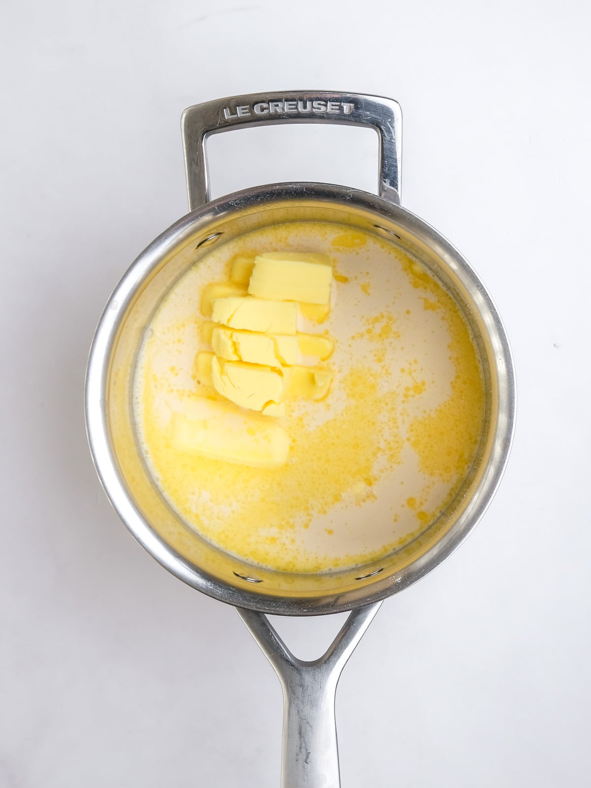 Image shows step 5 of how to make the malva pudding layer of this desert.